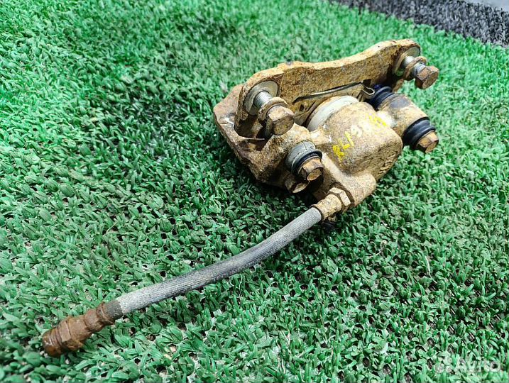 Суппорт тормозной задний левый Mitsubishi Pajero Sport