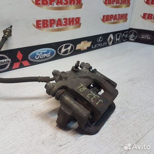 Суппорт тормозной задний левый Nissan Teana J32