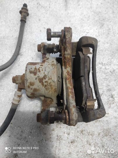 Суппорт тормозной передний Nissan Almera n15