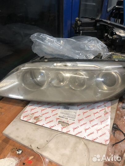 Фара левая mazda gg
