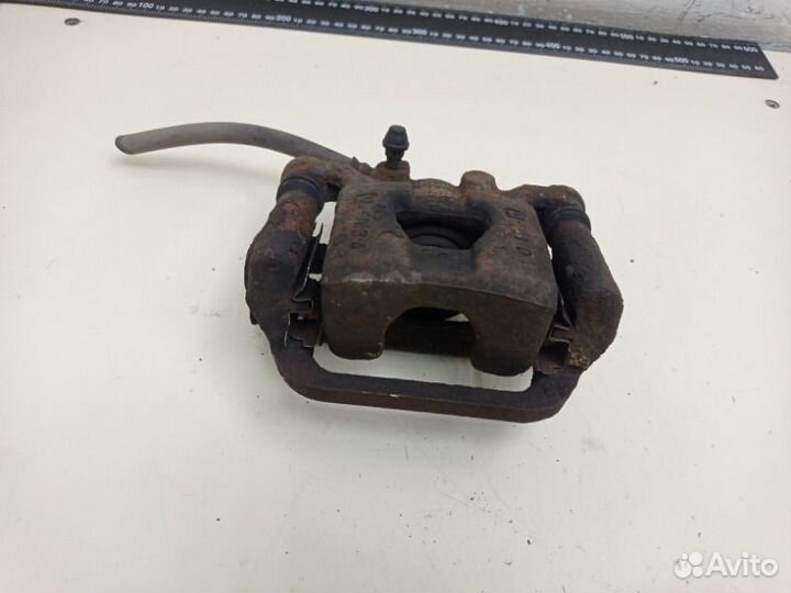 Суппорт тормозной задний левый Nissan Tiida HR16DE