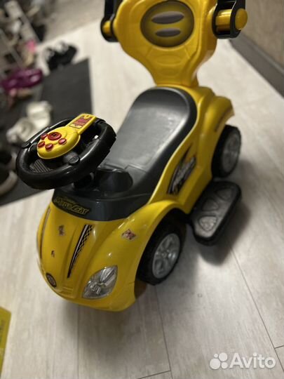 Детская машинка каталка с ручкой музыкальная