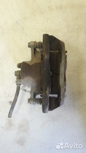 Суппорт тормозной передний левый Mitsubishi Lancer