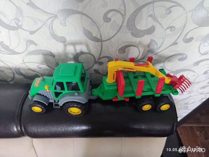 Трактор с прицепом, бревнами и цепляющим краном