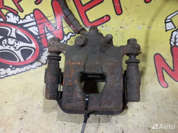 Суппорт тормозной задний левый Nissan Teana J31