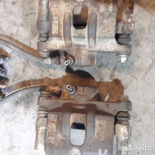 Суппорт левый задние Мицубиси Лансер 9