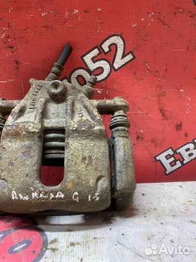 Суппорт тормозной передний левый Nissan Almera G15