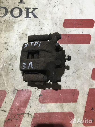 Суппорт тормозной задний левый Nissan X-Trail II