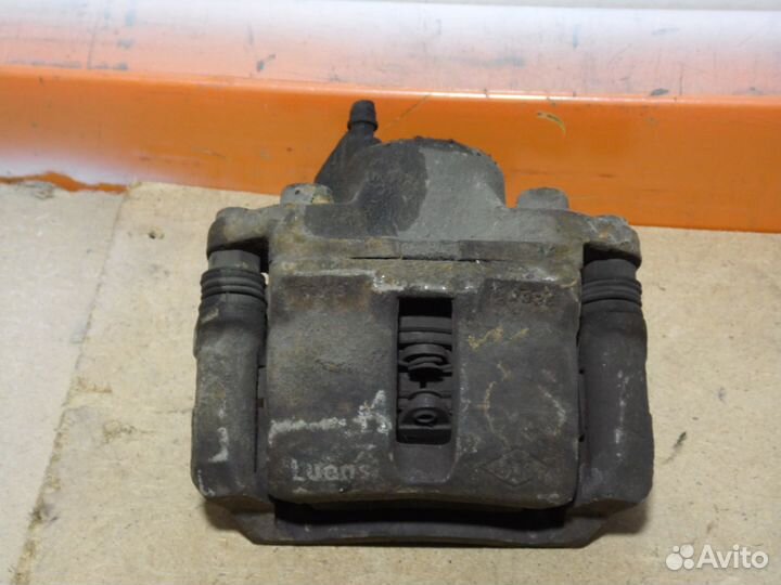 Суппорт тормозной передний левый Рено Логан