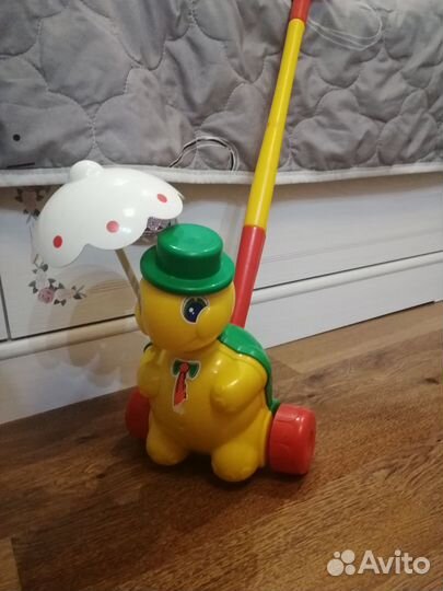 Игрушка каталка с ручкой