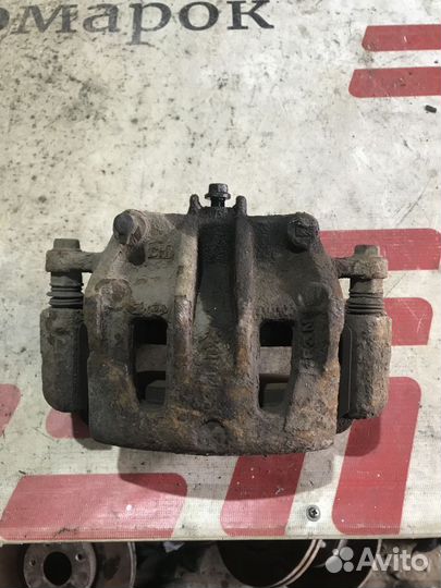 Суппорт тормозной передний левый Kia Sorento II (2