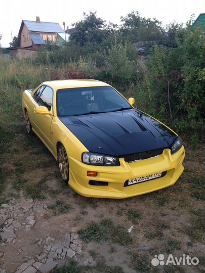 Передний бампер C-West на Nissan Skyline R34