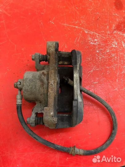 Суппорт тормозной передний левый Nissan Teana J32