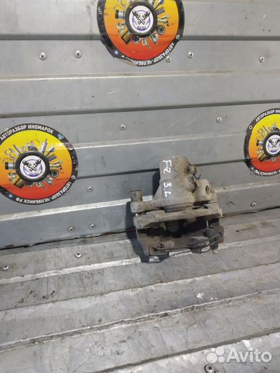 Суппорт тормозной задний левый Ford Focus 2