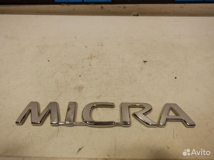 Эмблема Nissan Micra K12E CGA3DE