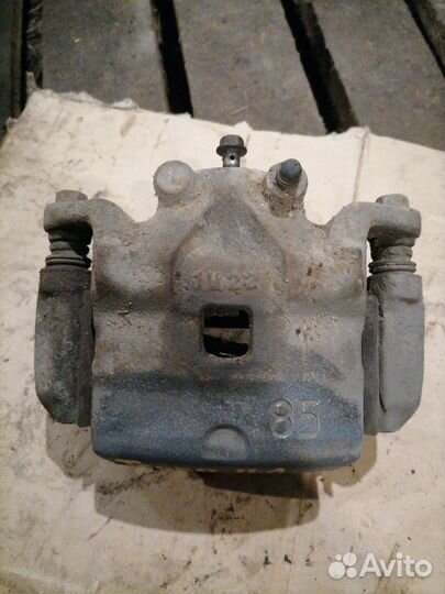 Суппорт тормозной передний левый Nissan Teana