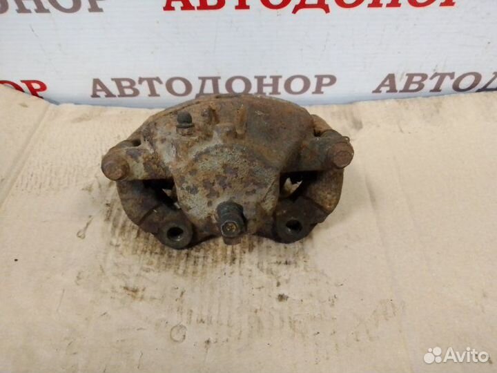 Суппорт тормозной передний левый Nissan Almera