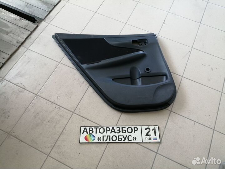 Обшивка двери задняя левая Toyota Corolla E150